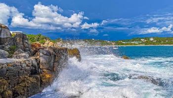 Beautiful surfer waves rocks cliffs at beach Puerto Escondido Mexico. photo