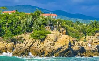 Beautiful surfer waves rocks cliffs at beach Puerto Escondido Mexico. photo