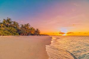 Landscape of paradise tropical island beach. Silhouette palm trees beautiful sunset sky, dream sea beach background. Tranquil travel holiday relax tourism. Closeup view of waves sunrise seaside nature photo