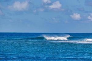 Beautiful panorama of splashing blue wave curl. Maldives island ocean lagoon with small waves splashing, idyllic nature scenic. Peaceful view photo