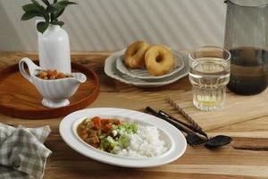 Breakfast with Japanese Curry, Rice, Lemon Water, and Donut photo