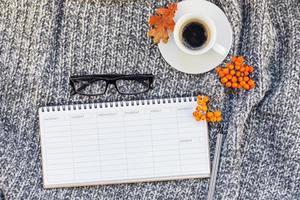 Home workplace with coffee cup on knitted plaid photo