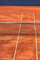 Empty Clay Tennis Court and Net photo