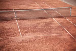 Empty Clay Tennis Court and Net photo