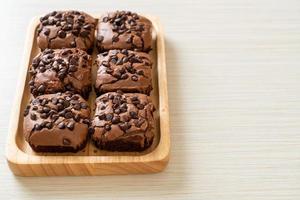 dark chocolate brownies topped by chocolate chips photo