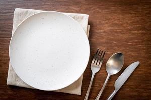 empty plate or dish with knife, fork and spoon photo