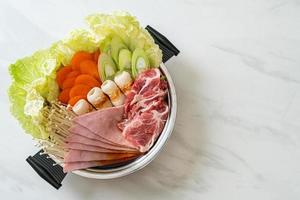 sukiyaki or shabu hot pot black soup with meat raw and vegetable photo