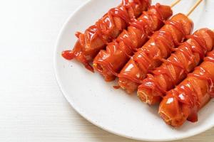 fried sausage skewer with ketchup photo