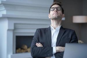 Mediative german businessman sit at desk with eyes closed taking rest from computer work photo