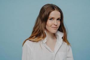 Confident beautiful teenage girl in white shirt smiling at camera photo