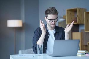 Confident European businessman team leader conducts video conference online meeting on laptop photo