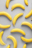 Geometric pattern of yellow bananas on a gray background in the Fashionable colors of 2021. photo