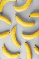 Geometric pattern of yellow bananas on a gray background in the Fashionable colors of 2021. photo