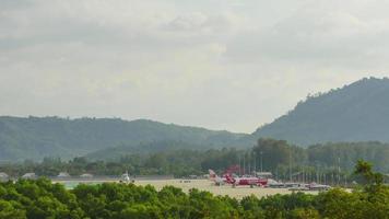 PHUKET, THAILAND NOVEMBER 26, 2019 - Airport Phuket Terminal with airplanes taxiing and landing. Timelapse. video