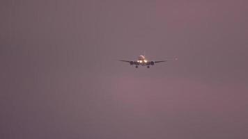 Widebody airplane approaching before landing on the Phuket airport against sunset sky. View from the top floor of the hotel near airport video