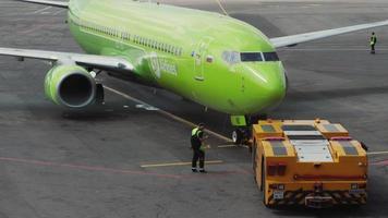 MOSCOW, RUSSIAN FEDERATION JULY 24, 2021 - Boeing passenger S7 airlines stands at the airport terminal, front view video