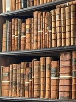 Old vintage blurred books on a bookshelf