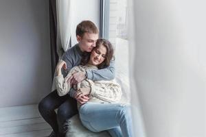 Romantic sexy couple in love having nice time together. Young woman hugging boyfriend, white background photo