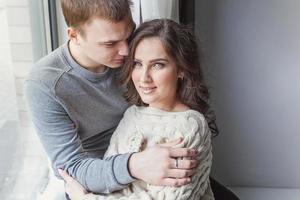 Romantic sexy couple in love having nice time together. Young woman hugging boyfriend, white background photo