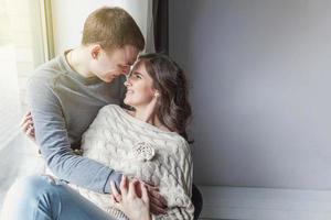 Romantic sexy couple in love having nice time together. Young woman hugging boyfriend, white background photo