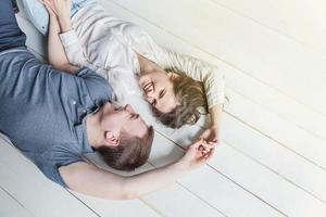 Romantic sexy couple in love having nice time together. Young woman hugging boyfriend, white background photo