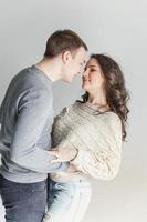 Romantic sexy couple in love having nice time together. Young woman hugging boyfriend, white background photo