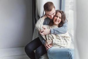 Romantic sexy couple in love having nice time together. Young woman hugging boyfriend, white background photo