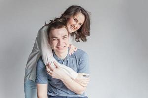 Romantic sexy couple in love having nice time together. Young woman hugging boyfriend, white background photo