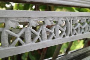 lined up human shaped wood carvings photo