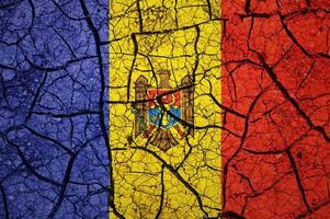 Dry soil pattern on the flag of Moldova. Country with drought concept. Water problem. Dry cracked earth country. photo