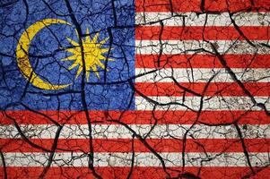 Dry soil pattern on the flag of Malaysia. Country with drought concept. Water problem. Dry cracked earth country. photo