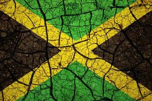 Dry soil pattern on the flag of Jamaica. Country with drought concept. Water problem. Dry cracked earth country. photo