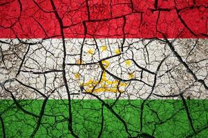 Dry soil pattern on the flag of Tajikistan. Country with drought concept. Water problem. Dry cracked earth country. photo