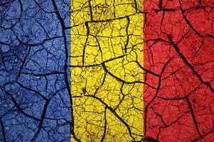 Dry soil pattern on the flag of Romania. Country with drought concept. Water problem. Dry cracked earth country. photo