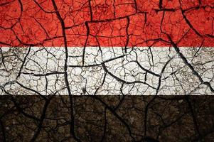 Dry soil pattern on the flag of Yemen. Country with drought concept. Water problem. Dry cracked earth country. photo