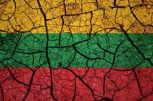 Dry soil pattern on the flag of Lithuania. Country with drought concept. Water problem. Dry cracked earth country. photo