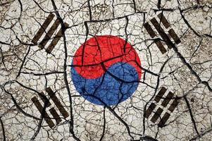 Dry soil pattern on the flag of South Korea. Country with drought concept. Water problem. Dry cracked earth country. photo