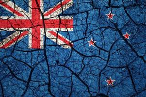 Dry soil pattern on the flag of New Zealand. Country with drought concept. Water problem. Dry cracked earth country. photo