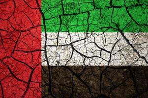 Dry soil pattern on the flag of United Arab Emirates. Country with drought concept. Water problem. Dry cracked earth country. photo