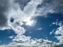 Clouds in a blue sky with sun photo