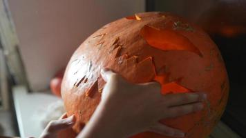 Close up on Hands and Knife Carving a Pumpkin video