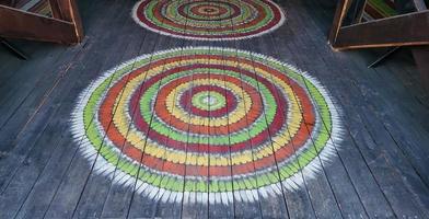 Perspective, the texture of a wooden floor with painted round rustic rugs photo