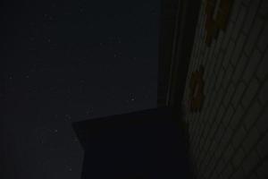 The starry sky and the roofs of houses. Astrophotography in a village with houses. photo