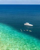 Maldivian exotic diving boat in amazing ocean lagoon over coral ref. Snorkel and outdoor adventure, activity travel landscape concept. Aerial sea view, tranquil nature, luxury travel vacation scenic photo