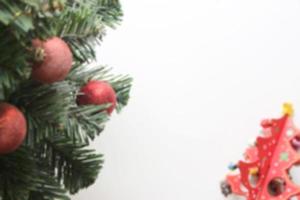 blurred christmas tree with decorations ball on white background photo
