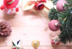 blurred christmas tree background with decorations on wooden board photo