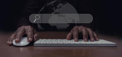 man's hand using mouse and keyboard to search for information, Searching for information in the big world photo