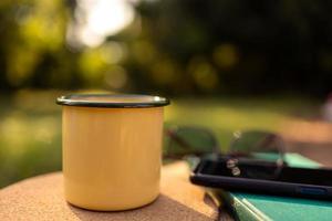 Coffee mugs in the backyard and morning sunshine. photo