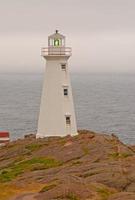 Lighthouse on a cloudy coast photo