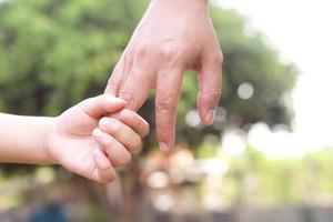 manos de los niños con cuidado, preocupación, calidez de las madres. foto